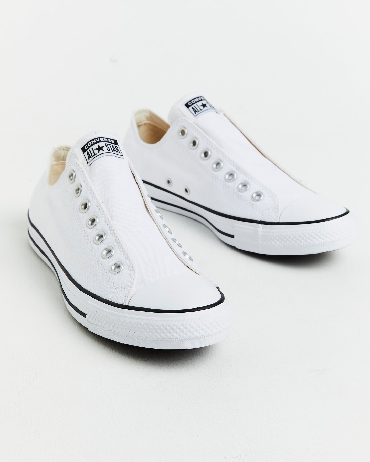 Chuck Taylor All Star Slip On Sneakers In White/Black