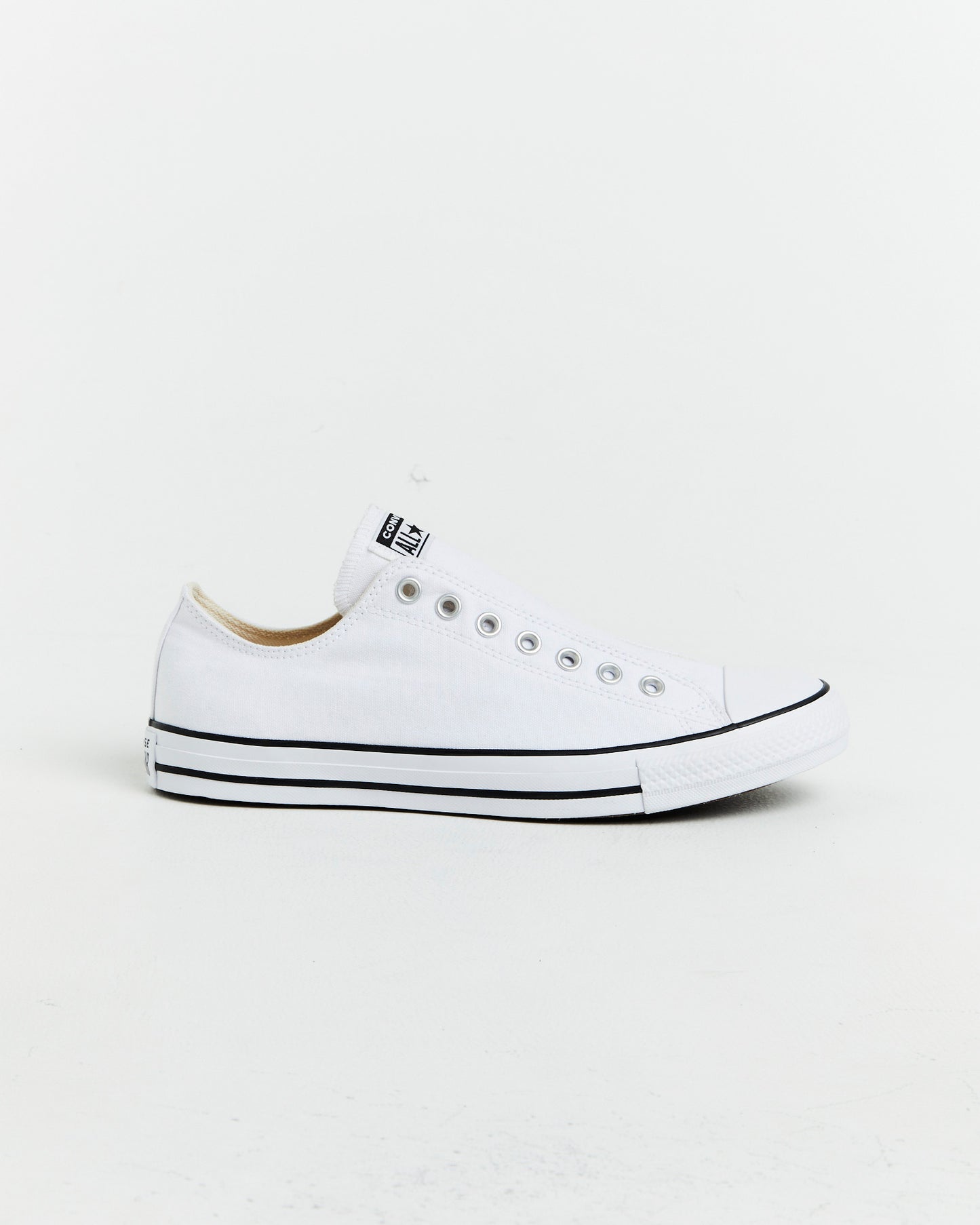 Chuck Taylor All Star Slip On Sneakers In White/Black