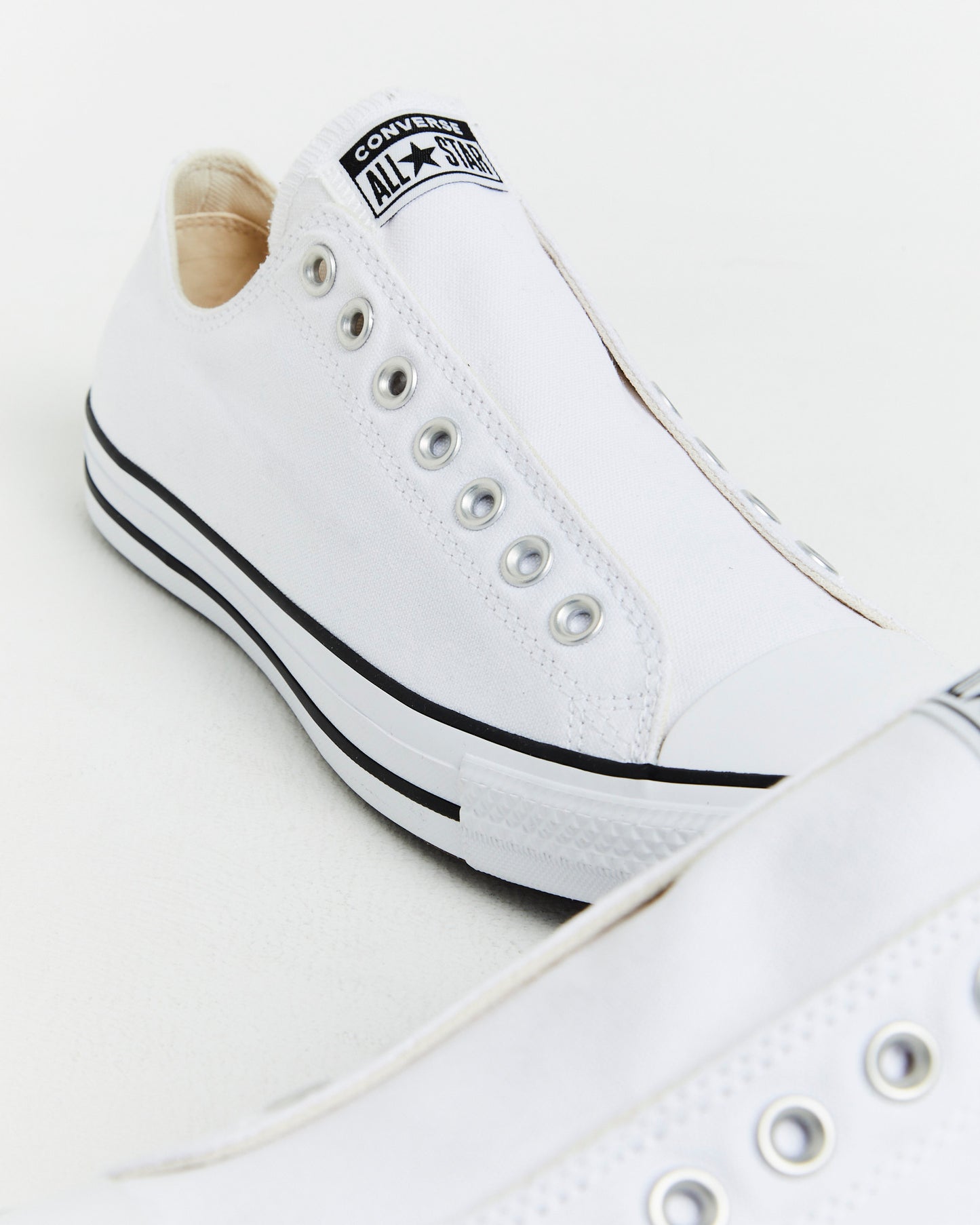 Chuck Taylor All Star Slip On Sneakers In White/Black