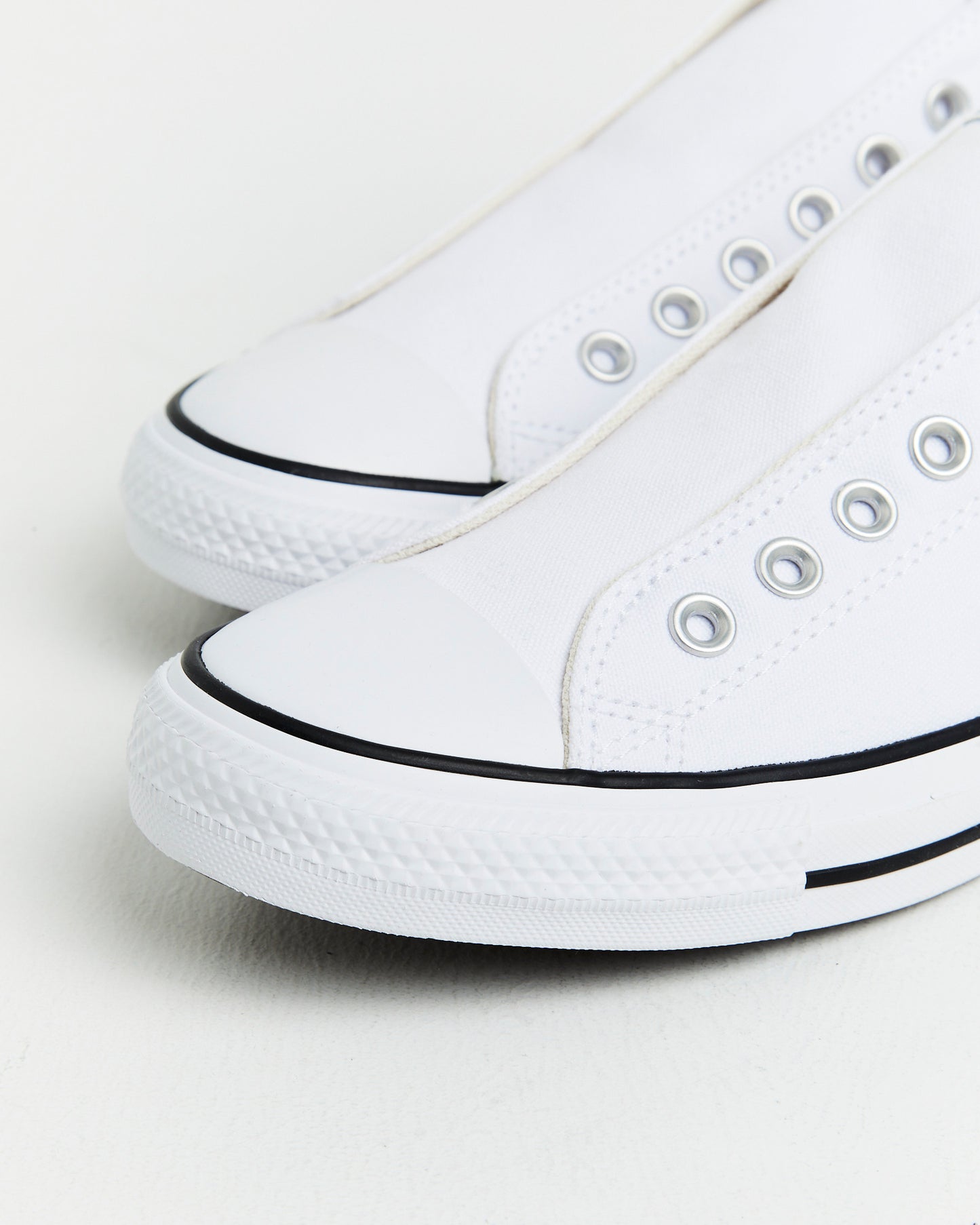 Chuck Taylor All Star Slip On Sneakers In White/Black